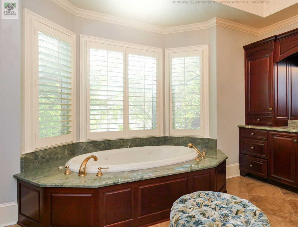 Large master bathroom in San Francisco with dark wood cabinets, a hot tub, a two-piece toilet, green walls, marble benchtops, beige floor, green benchtops, an enclosed toilet, a double vanity, a built-in vanity and coffered.