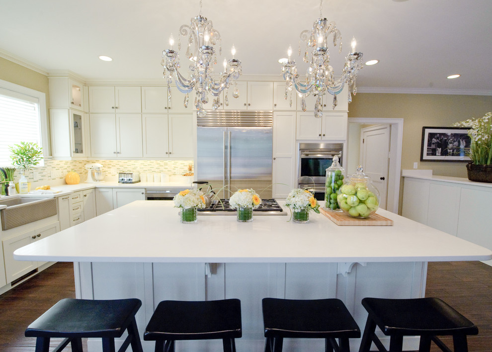 Inspiration for a timeless l-shaped kitchen remodel in Bridgeport with a farmhouse sink, shaker cabinets, white cabinets and stainless steel appliances