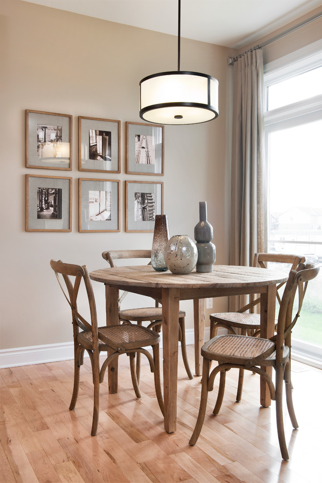 Mid-sized transitional open plan dining in Ottawa with beige walls, light hardwood floors and no fireplace.