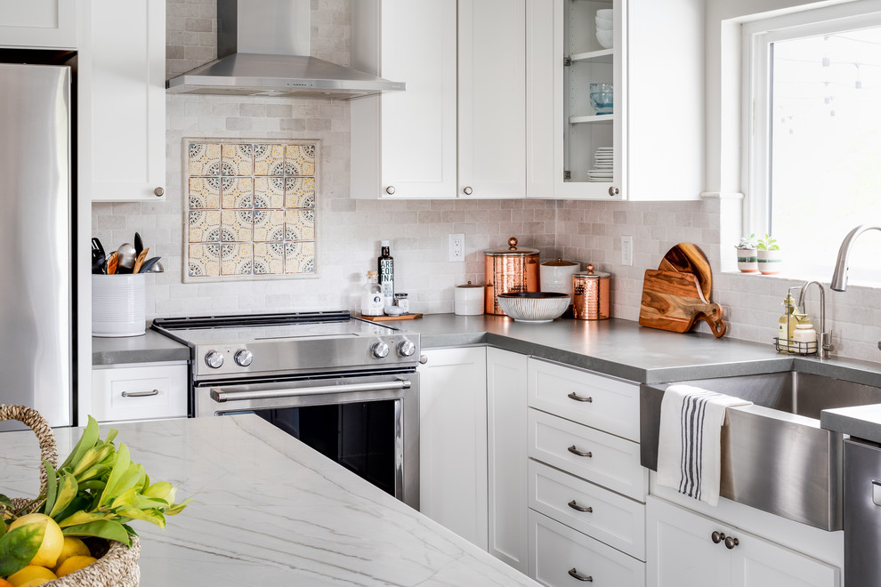 Design ideas for a mid-sized transitional l-shaped eat-in kitchen in San Diego with a farmhouse sink, shaker cabinets, white cabinets, quartzite benchtops, stainless steel appliances, with island and grey benchtop.