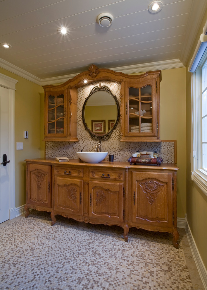 Photo of an expansive country bathroom in Vancouver with furniture-like cabinets, medium wood cabinets, multi-coloured tile, mosaic tile and yellow walls.