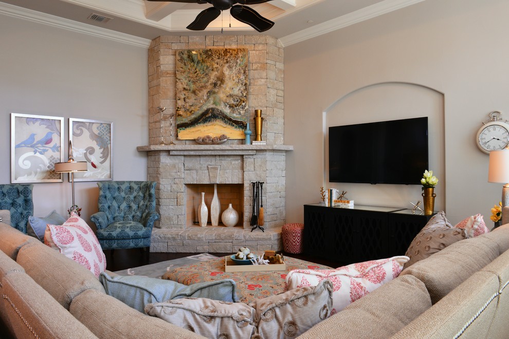 Inspiration for a mid-sized transitional open concept family room in Dallas with beige walls, dark hardwood floors, a corner fireplace, a stone fireplace surround, a wall-mounted tv and brown floor.