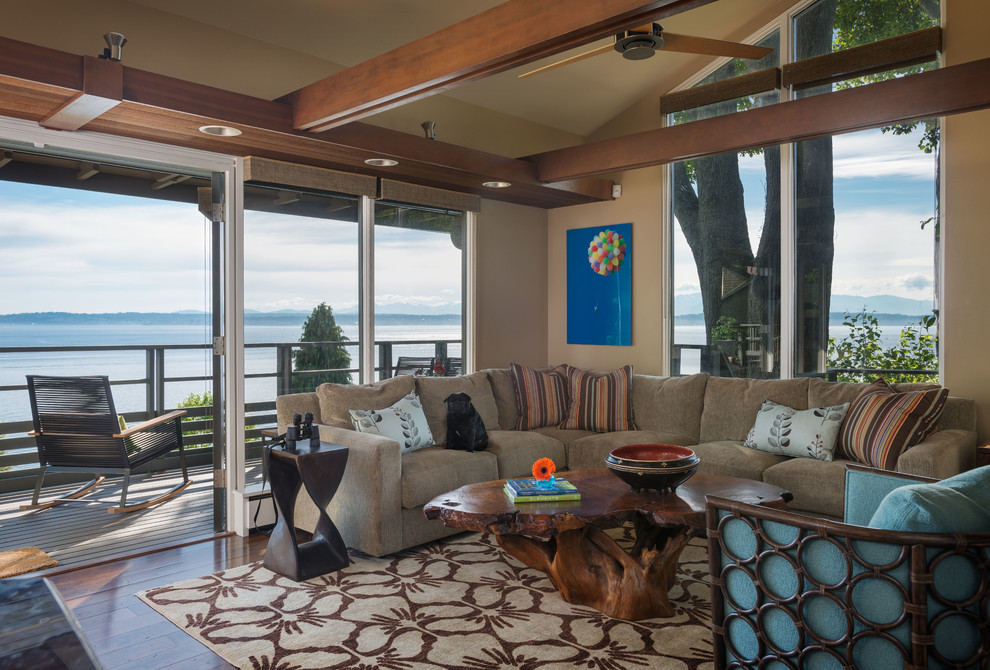 This is an example of a contemporary family room in Seattle with beige walls and dark hardwood floors.
