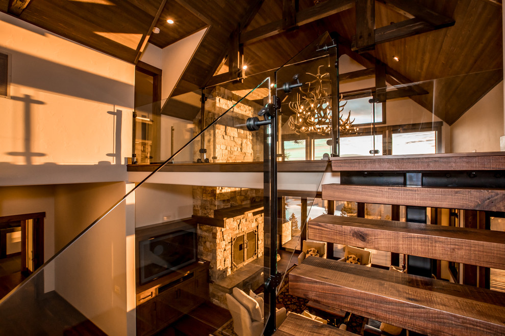 Inspiration for a contemporary wood straight staircase in Other with open risers and glass railing.