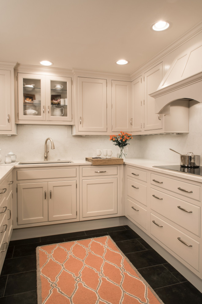Small transitional ceramic tile and black floor eat-in kitchen photo with an undermount sink, beaded inset cabinets, gray cabinets, white backsplash, stainless steel appliances and white countertops
