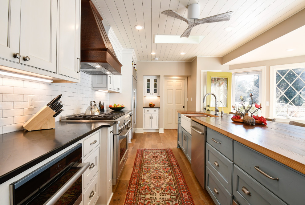 Design ideas for a large transitional l-shaped kitchen in DC Metro with a farmhouse sink, recessed-panel cabinets, marble benchtops, stainless steel appliances and with island.