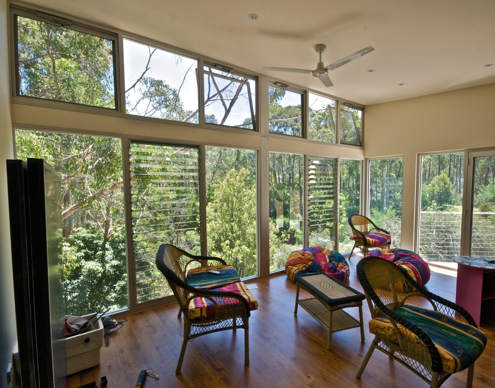 Mid-sized modern open concept family room in Adelaide with white walls and medium hardwood floors.