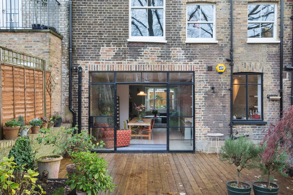 Inspiration for a large eclectic two-storey brick townhouse exterior in London.