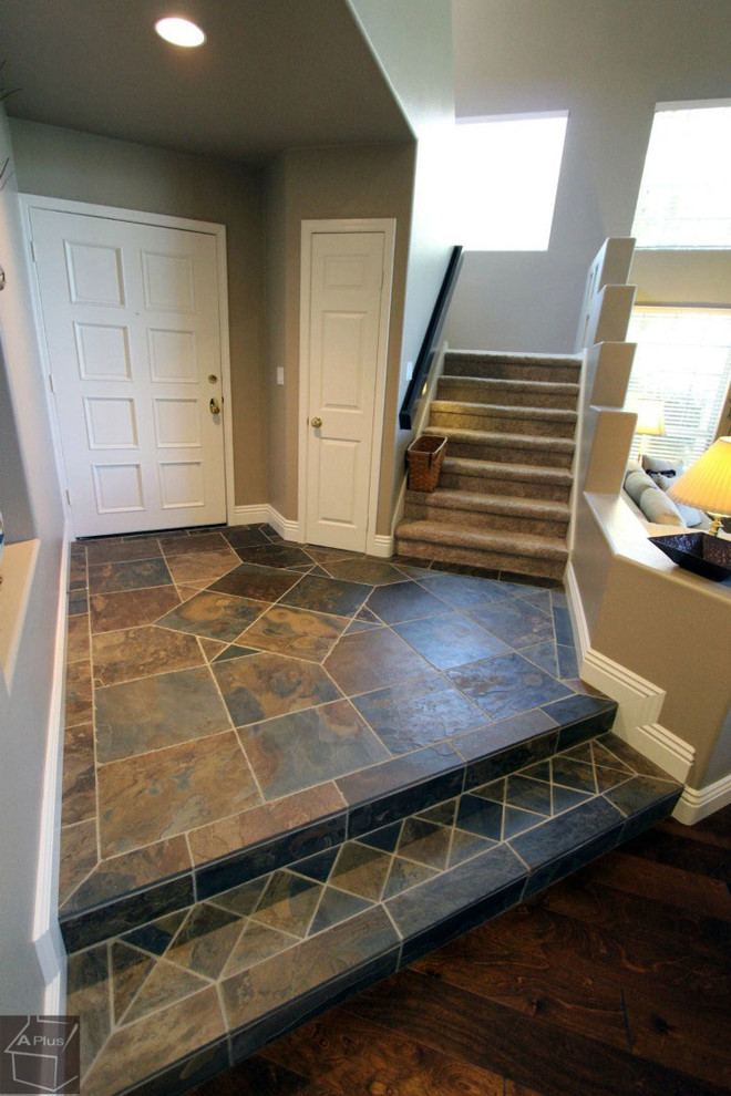 This is an example of a mid-sized transitional foyer in Orange County with beige walls and porcelain floors.
