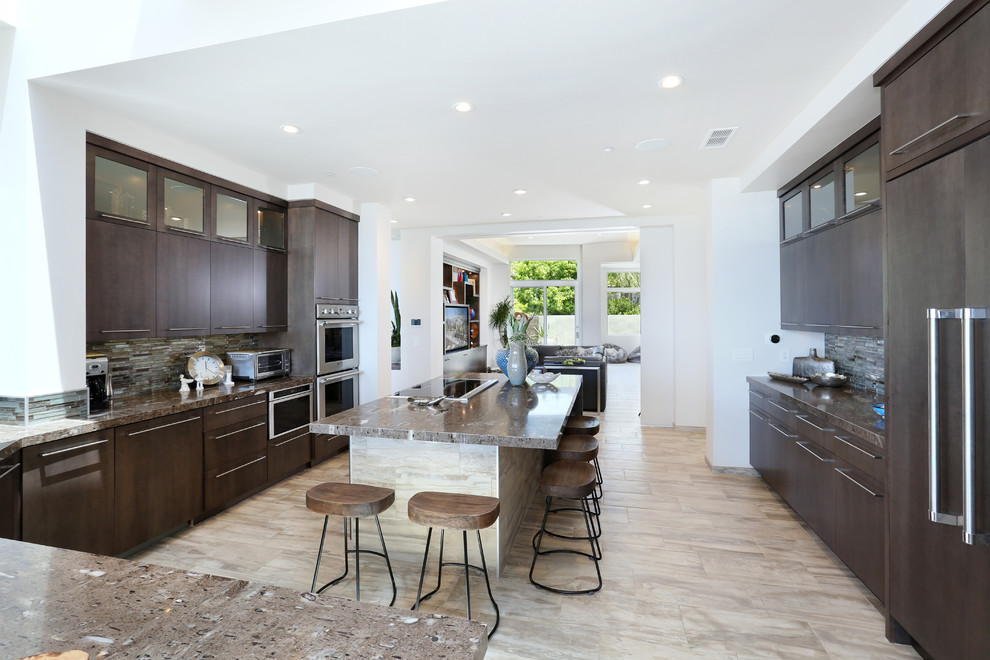 Inspiration for a transitional open plan kitchen in Orange County with flat-panel cabinets, dark wood cabinets, quartzite benchtops, multi-coloured splashback, glass tile splashback, stainless steel appliances, ceramic floors and with island.