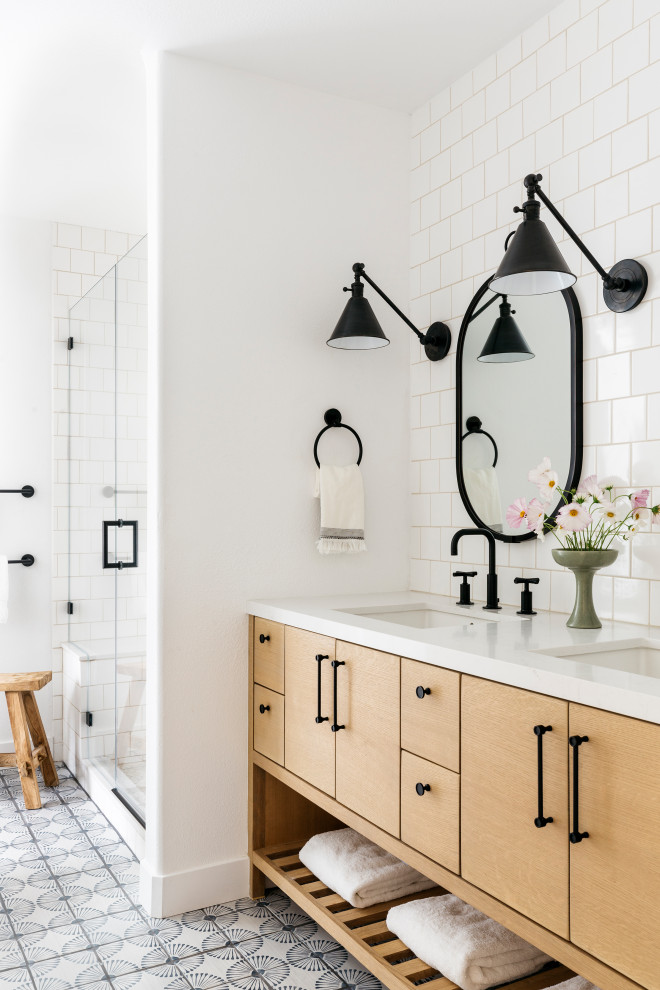Mid-sized farmhouse 3/4 white tile and ceramic tile terra-cotta tile, blue floor and double-sink alcove shower photo in San Francisco with light wood cabinets, a two-piece toilet, white walls, an undermount sink, quartz countertops, a hinged shower door, white countertops, a built-in vanity and flat-panel cabinets