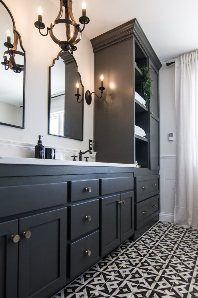Photo of a mid-sized transitional master bathroom in Minneapolis with shaker cabinets, black cabinets, a freestanding tub, a corner shower, porcelain floors, an undermount sink, engineered quartz benchtops, multi-coloured floor, a hinged shower door, white benchtops, a double vanity and a built-in vanity.