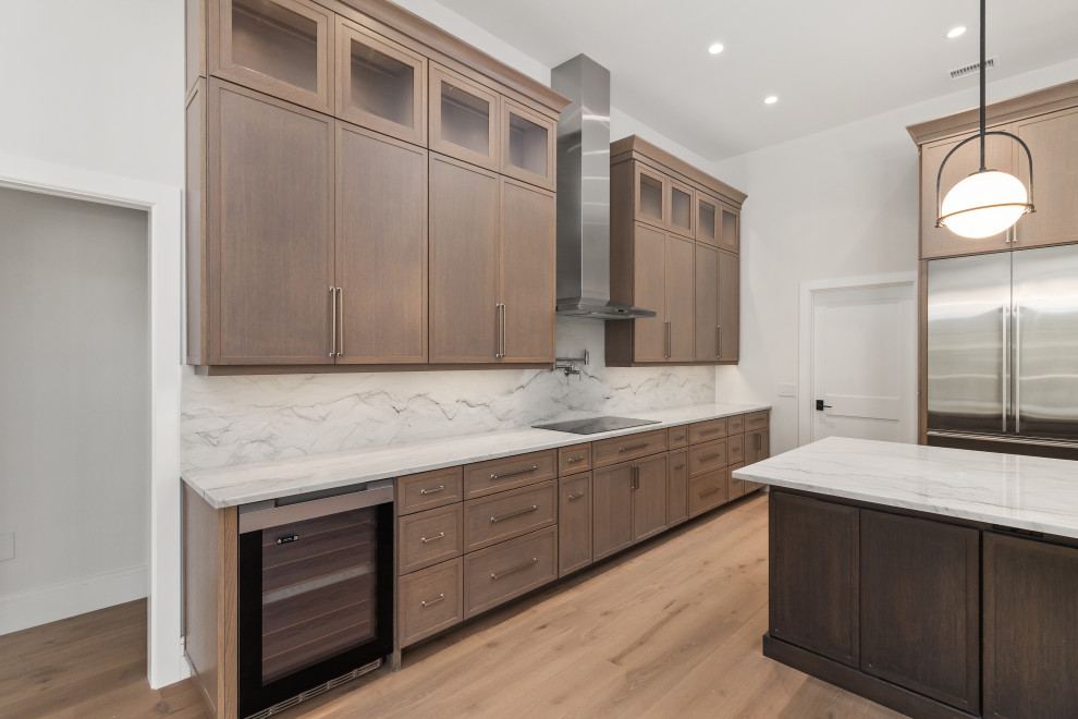 Example of a large transitional galley light wood floor and brown floor eat-in kitchen design in Tampa with a double-bowl sink, shaker cabinets, dark wood cabinets, quartz countertops, gray backsplash, stone slab backsplash, stainless steel appliances, an island and gray countertops