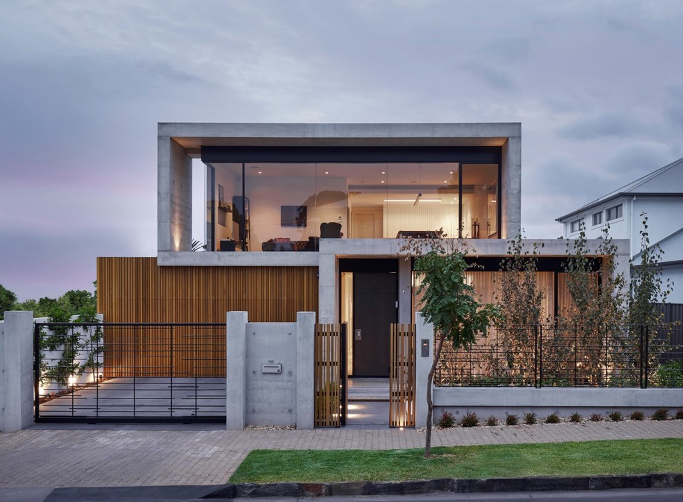 Photo of a contemporary two-storey brown house exterior in Adelaide with mixed siding and a flat roof.