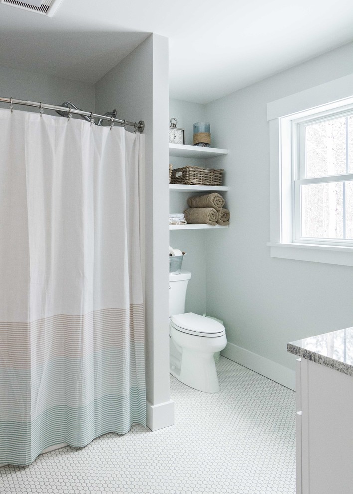 This is an example of a mid-sized country kids bathroom in Portland Maine with shaker cabinets, white cabinets, a shower/bathtub combo, grey walls, porcelain floors, an undermount sink, granite benchtops, white floor, a shower curtain, an alcove tub and a two-piece toilet.