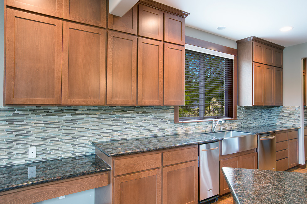 Inspiration for a craftsman dark wood floor kitchen remodel in Seattle with a farmhouse sink, shaker cabinets, medium tone wood cabinets, granite countertops, multicolored backsplash, mosaic tile backsplash, stainless steel appliances and no island