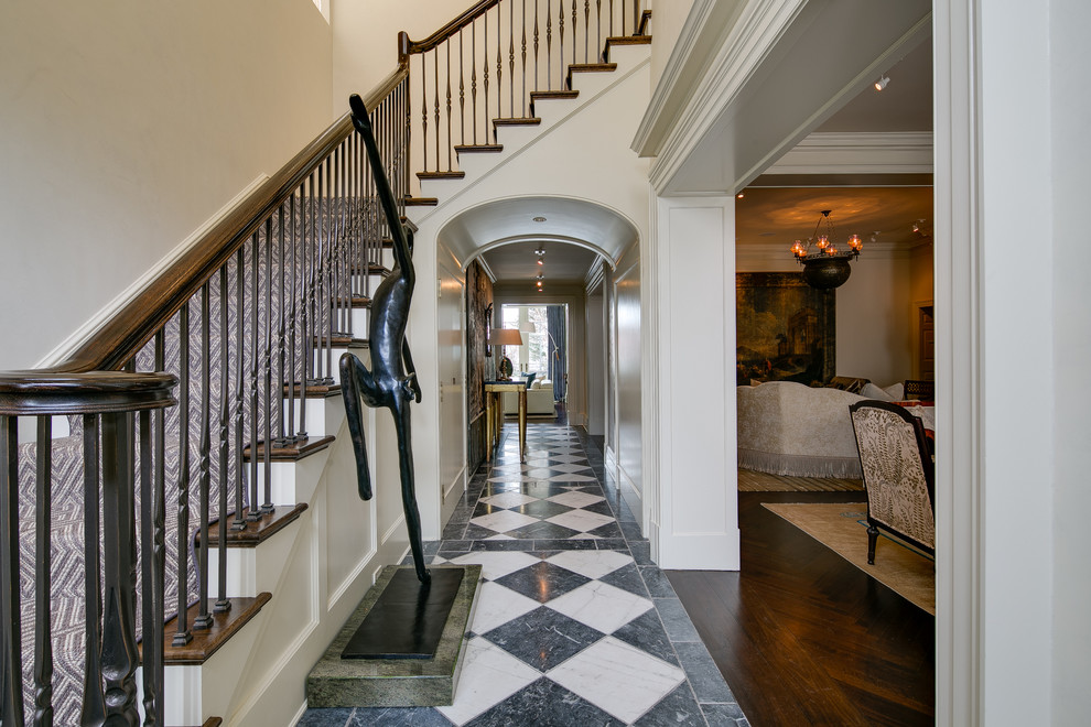 Design ideas for a traditional entryway in DC Metro with white walls and marble floors.
