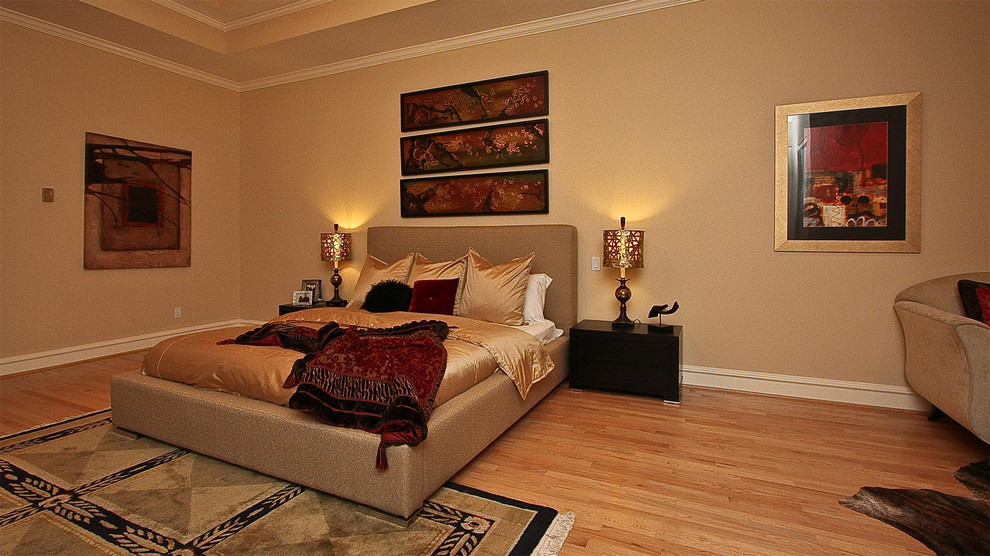 Design ideas for a large modern master bedroom in Dallas with beige walls, light hardwood floors and no fireplace.