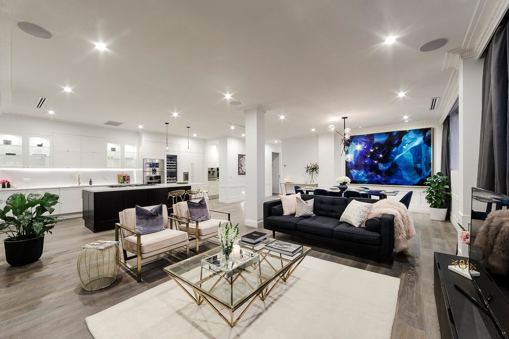 Contemporary open concept living room in Melbourne with white walls, dark hardwood floors and a freestanding tv.