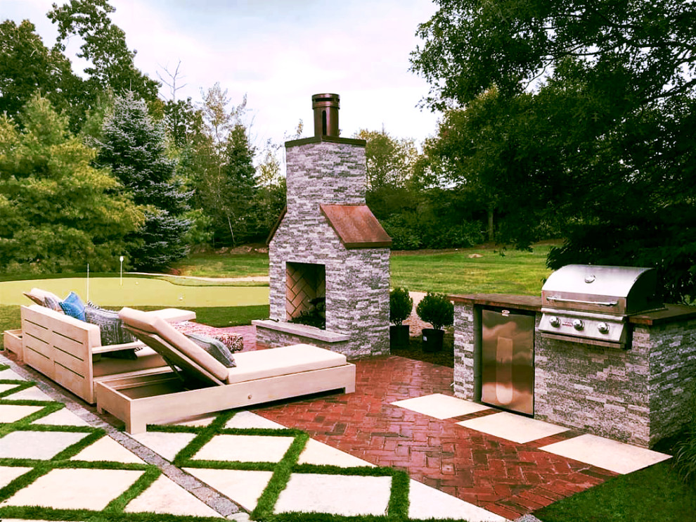 Photo of a small contemporary backyard full sun garden in Boston with with fireplace and decomposed granite.