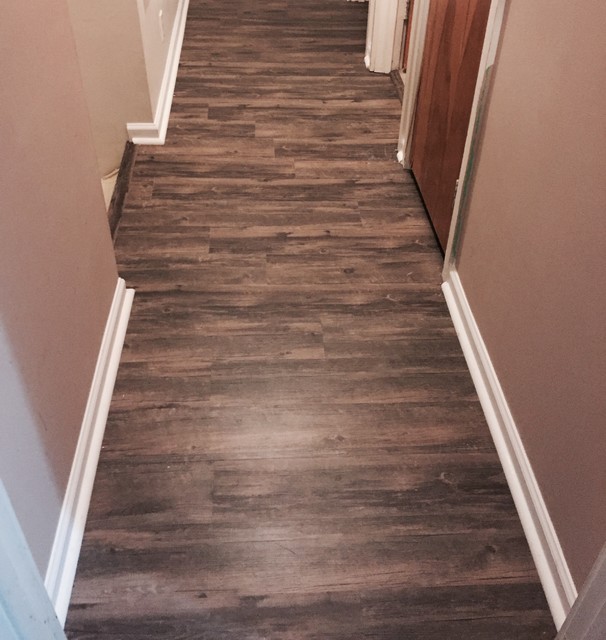 Vinyl Plank Flooring And Trim Quarter Round Installed Hallway