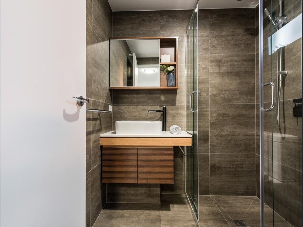 This is an example of a modern master bathroom in Brisbane with furniture-like cabinets, a corner shower, ceramic floors and a sliding shower screen.