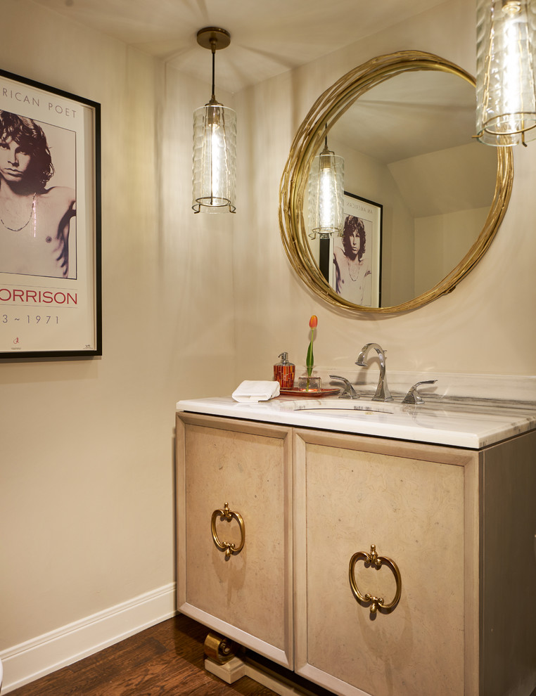 Mid-sized transitional powder room in Other with furniture-like cabinets, light wood cabinets, a one-piece toilet, grey walls, medium hardwood floors, an undermount sink, marble benchtops and brown floor.