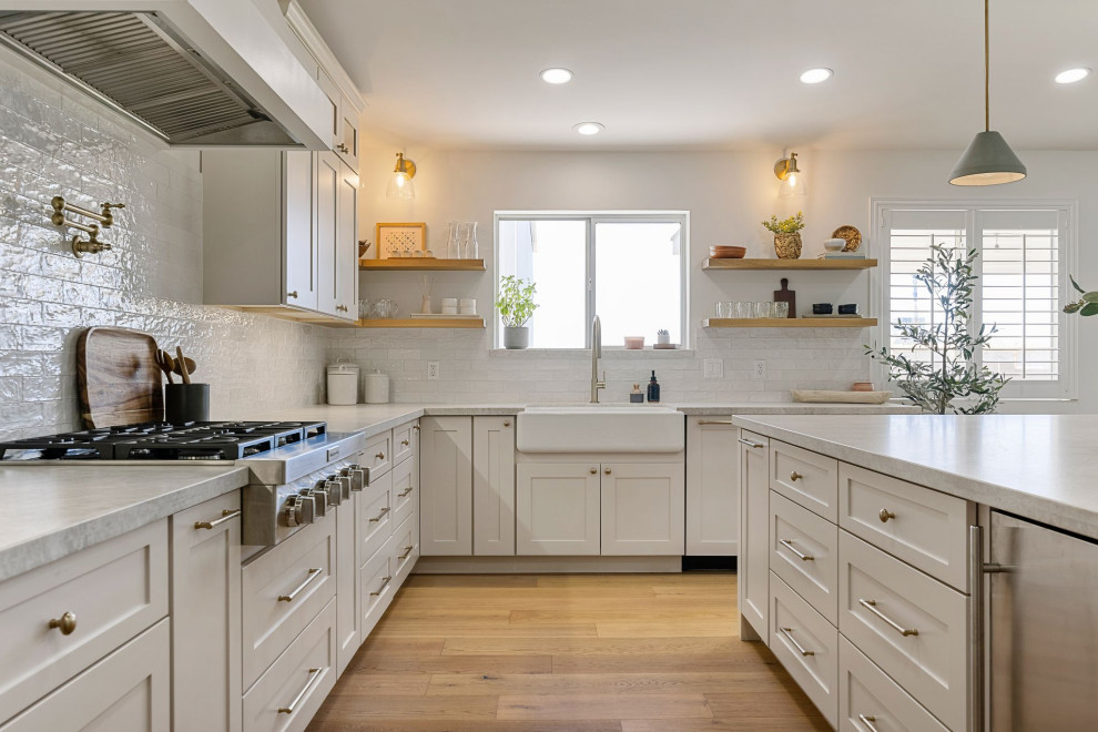 Inspiration for a large transitional u-shaped eat-in kitchen remodel in Phoenix with shaker cabinets, gray cabinets, white backsplash, stainless steel appliances and an island