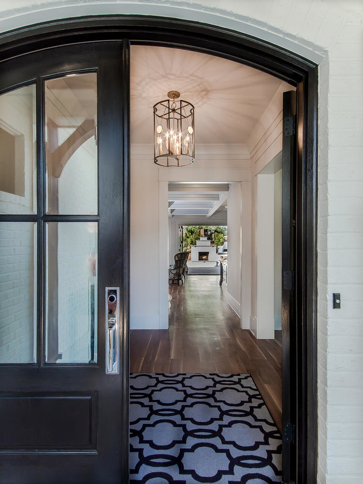 Entryway - mid-sized transitional two-story stucco white entryway idea in Raleigh with a clipped gable roof and a tile roof
