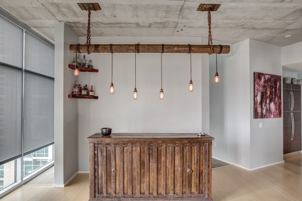 This is an example of a mid-sized industrial single-wall wet bar in Nashville with no sink, dark wood cabinets, wood benchtops, bamboo floors, beige floor and brown benchtop.