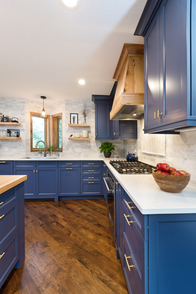 Foto på ett mellanstort funkis vit kök, med en dubbel diskho, skåp i shakerstil, blå skåp, bänkskiva i kvarts, beige stänkskydd, stänkskydd i stenkakel, rostfria vitvaror, mellanmörkt trägolv, en köksö och brunt golv