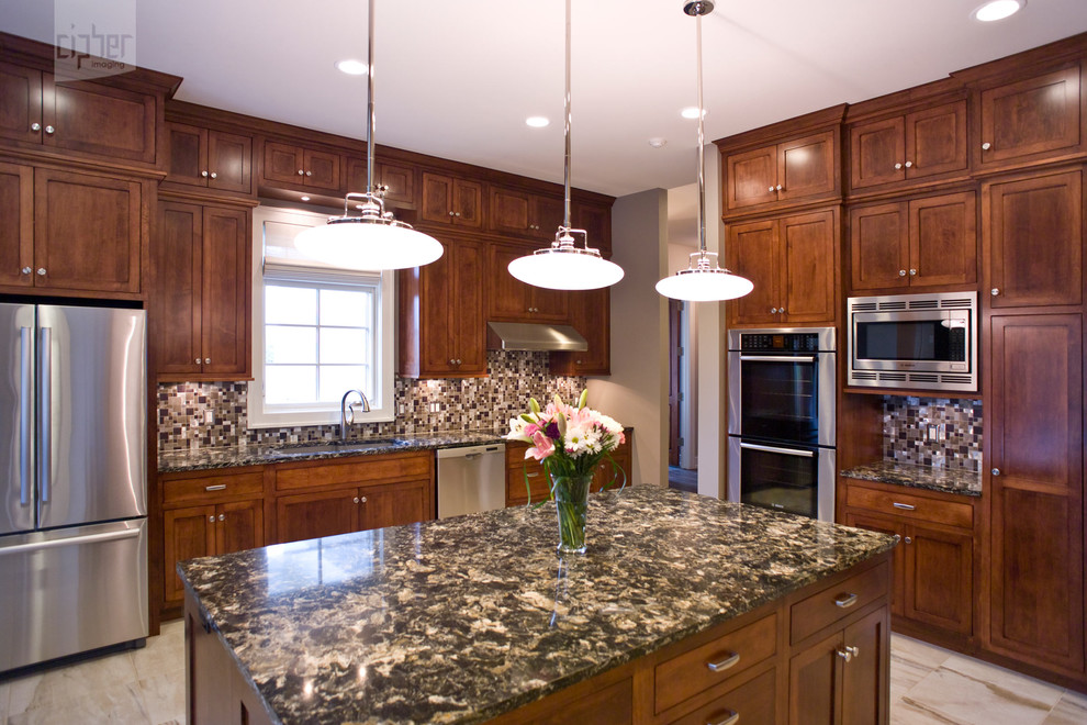 Inspiration for a mid-sized transitional l-shaped porcelain tile and multicolored floor enclosed kitchen remodel with an undermount sink, recessed-panel cabinets, medium tone wood cabinets, multicolored backsplash, stainless steel appliances, beige walls, an island, granite countertops and mosaic tile backsplash