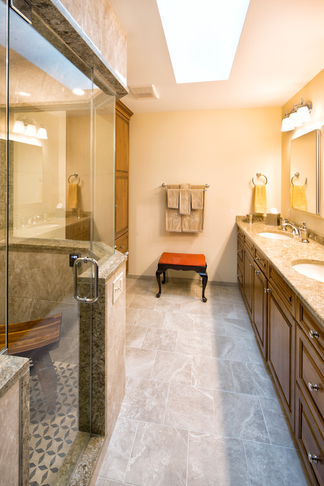 Transitional master porcelain tile bathroom photo with raised-panel cabinets, light wood cabinets, a two-piece toilet, an undermount sink and quartz countertops