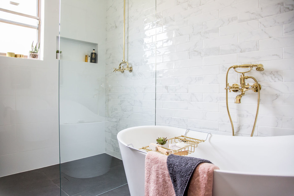 Photo of a transitional master bathroom in Adelaide with a freestanding tub, a corner shower, gray tile, white tile, subway tile, white walls, grey floor and an open shower.