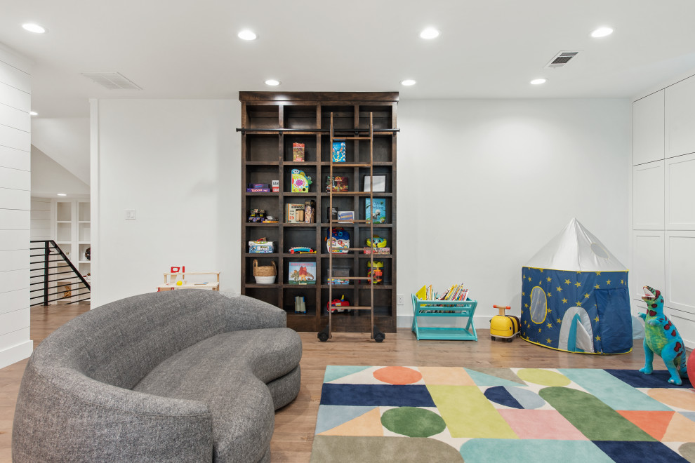 Design ideas for a mid-sized transitional enclosed family room in Dallas with a game room, white walls, medium hardwood floors and a built-in media wall.