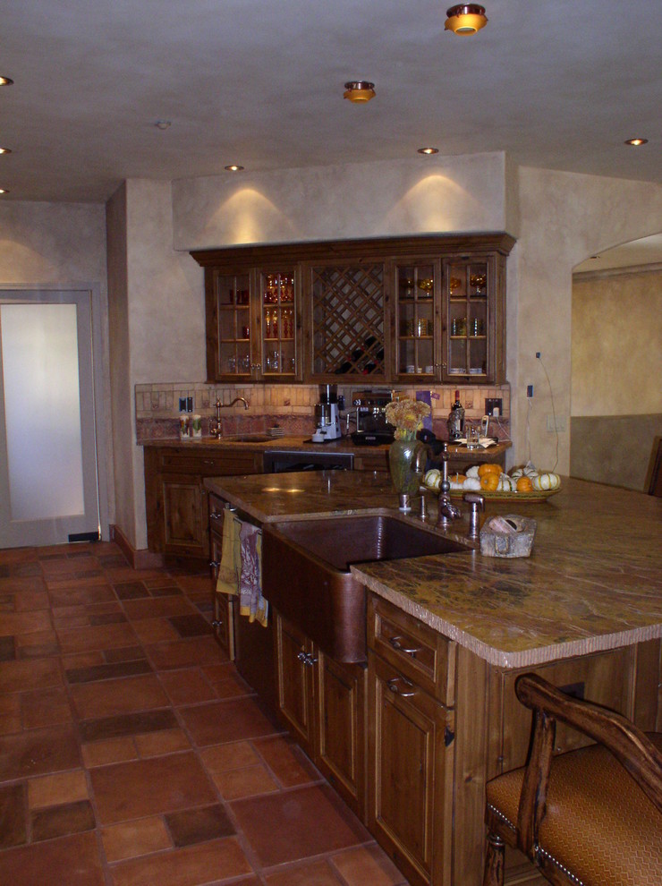 Mountain style u-shaped kitchen pantry photo in Los Angeles with raised-panel cabinets, medium tone wood cabinets, beige backsplash and an island