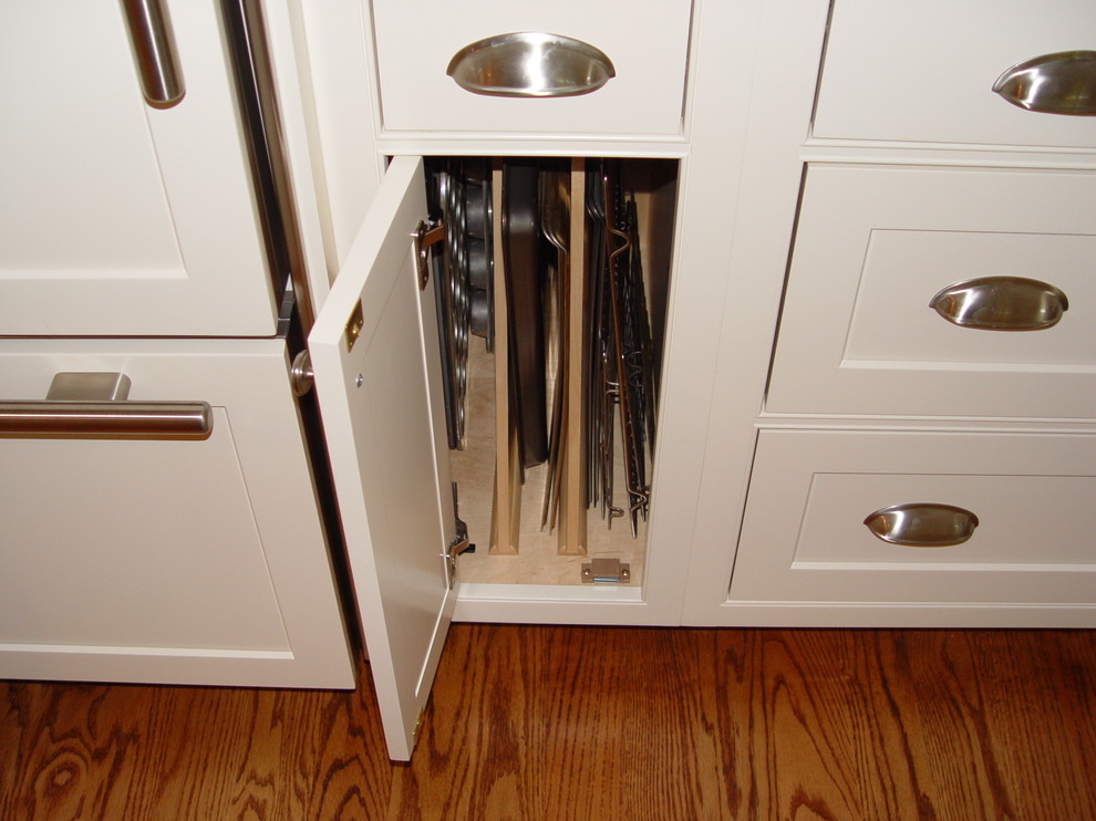 Inspiration for a transitional medium tone wood floor eat-in kitchen remodel in Boston with an undermount sink, beaded inset cabinets, white cabinets, granite countertops, white backsplash, subway tile backsplash, paneled appliances, yellow walls and an island