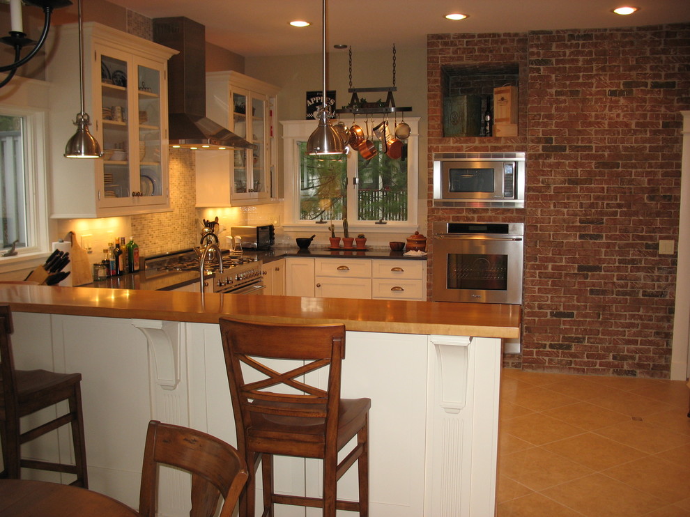 This is an example of a transitional kitchen in New York with a peninsula.