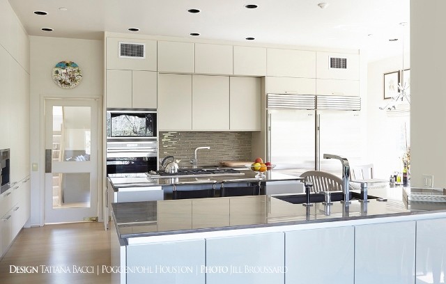 Kitchen pantry - large transitional light wood floor kitchen pantry idea in Houston with a single-bowl sink, flat-panel cabinets, black cabinets, quartzite countertops, metallic backsplash, terra-cotta backsplash, stainless steel appliances and an island