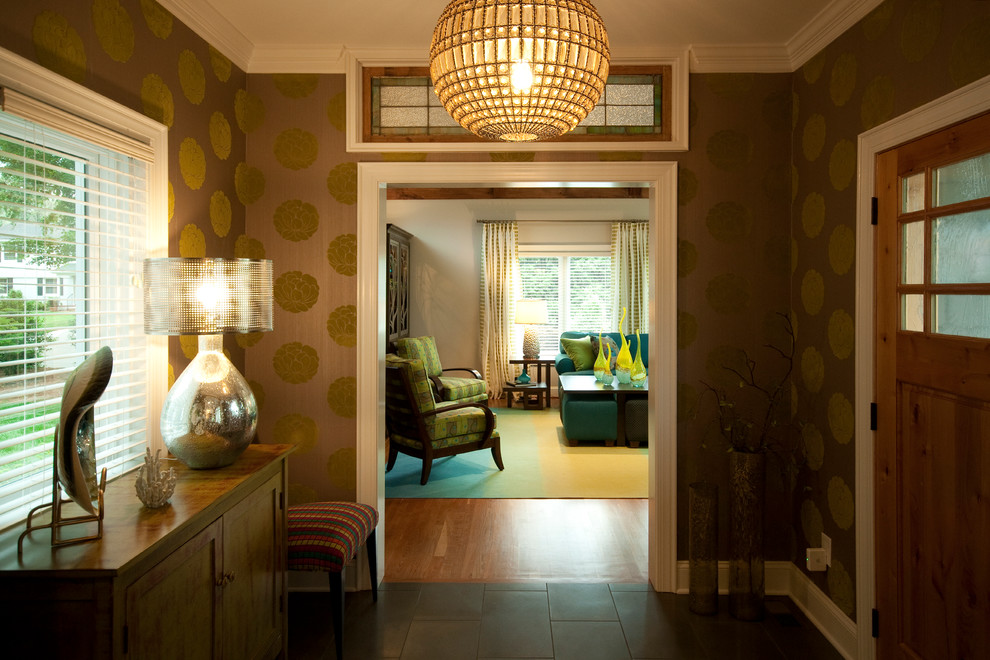 Foyer - mid-sized transitional ceramic tile foyer idea in Charlotte with a medium wood front door and brown walls