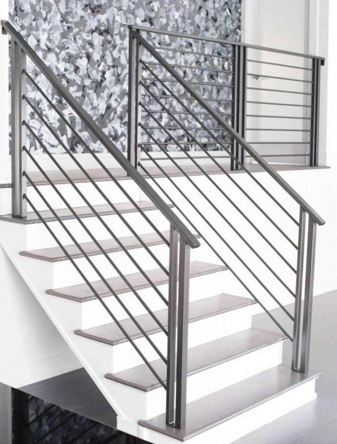 Mid-sized modern staircase in Seattle with metal railing.