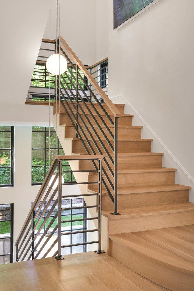 Photo of a contemporary wood staircase in Minneapolis with wood risers.