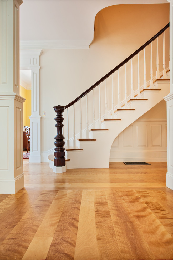 Design ideas for a large traditional foyer in Boston with white walls and light hardwood floors.