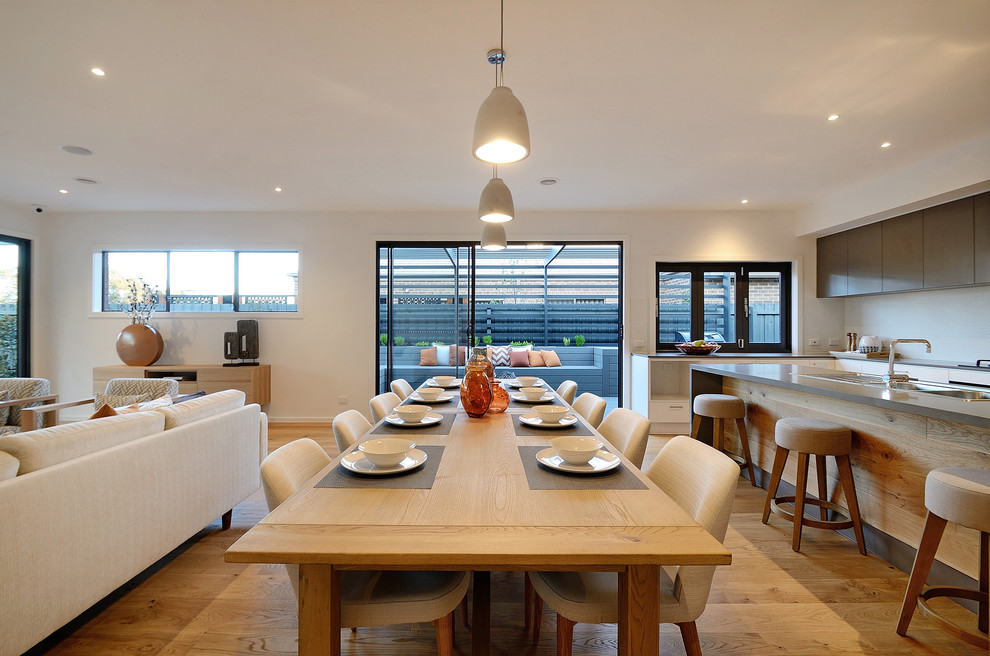 Design ideas for a mid-sized contemporary kitchen/dining combo in Melbourne with medium hardwood floors.