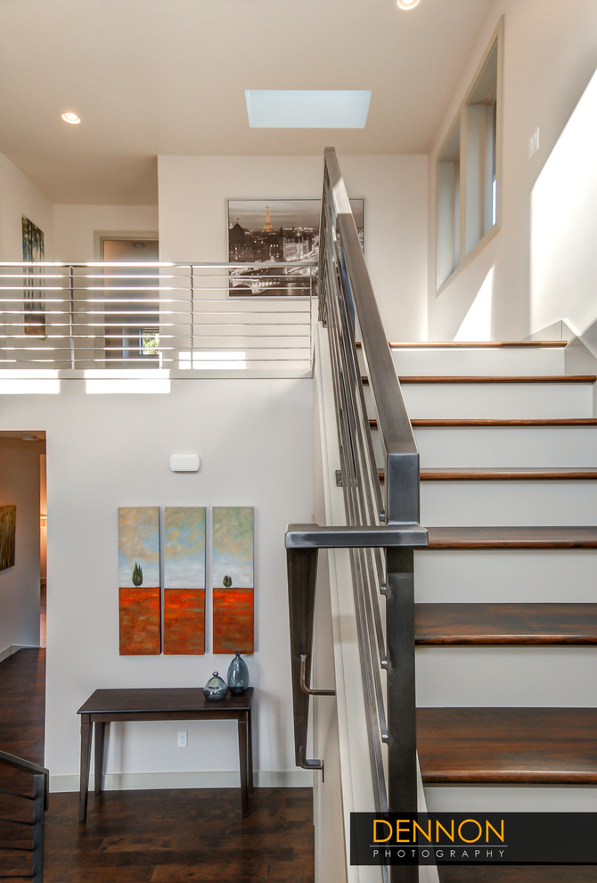 Mid-sized transitional wood u-shaped staircase in Seattle with painted wood risers and metal railing.