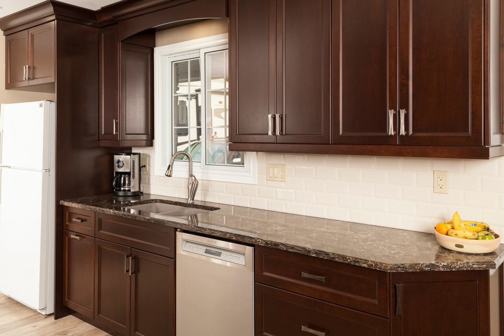 Example of a transitional kitchen design in Toronto with shaker cabinets, dark wood cabinets, granite countertops, white backsplash, subway tile backsplash and stainless steel appliances
