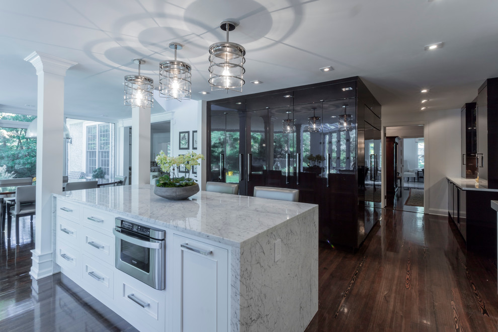 Large transitional galley dark wood floor eat-in kitchen photo in Philadelphia with an undermount sink, recessed-panel cabinets, white cabinets, white backsplash, an island, quartzite countertops, ceramic backsplash and paneled appliances