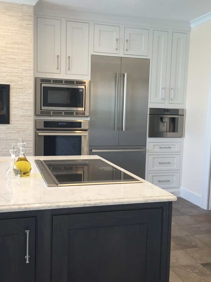 Kitchen - large transitional ceramic tile and multicolored floor kitchen idea with a farmhouse sink, beaded inset cabinets, white cabinets, quartz countertops, metallic backsplash, ceramic backsplash, stainless steel appliances and an island
