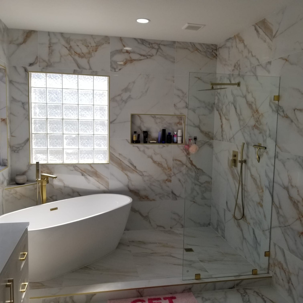 Retro inredning av ett stort vit vitt en-suite badrum, med släta luckor, vita skåp, ett fristående badkar, våtrum, flerfärgad kakel, porslinskakel, flerfärgade väggar, klinkergolv i porslin, ett nedsänkt handfat, marmorbänkskiva, flerfärgat golv och med dusch som är öppen