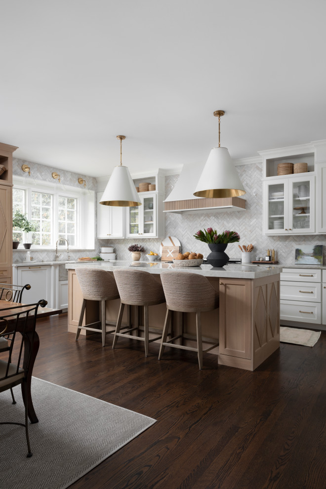 Inspiration for a mid-sized transitional u-shaped open plan kitchen in Chicago with a farmhouse sink, flat-panel cabinets, white cabinets, quartzite benchtops, white splashback, terra-cotta splashback, panelled appliances, dark hardwood floors, with island, brown floor, grey benchtop and wood.